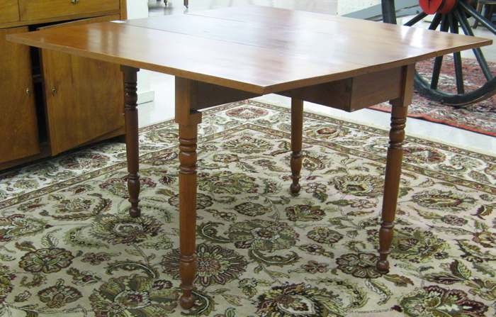 Appraisal: VICTORIAN DROP-LEAF CHERRYWOOD DINING TABLE American c the narrow table