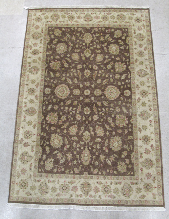 Appraisal: HAND KNOTTED ORIENTAL CARPET Pakistani-Persian overall floral design on mocha