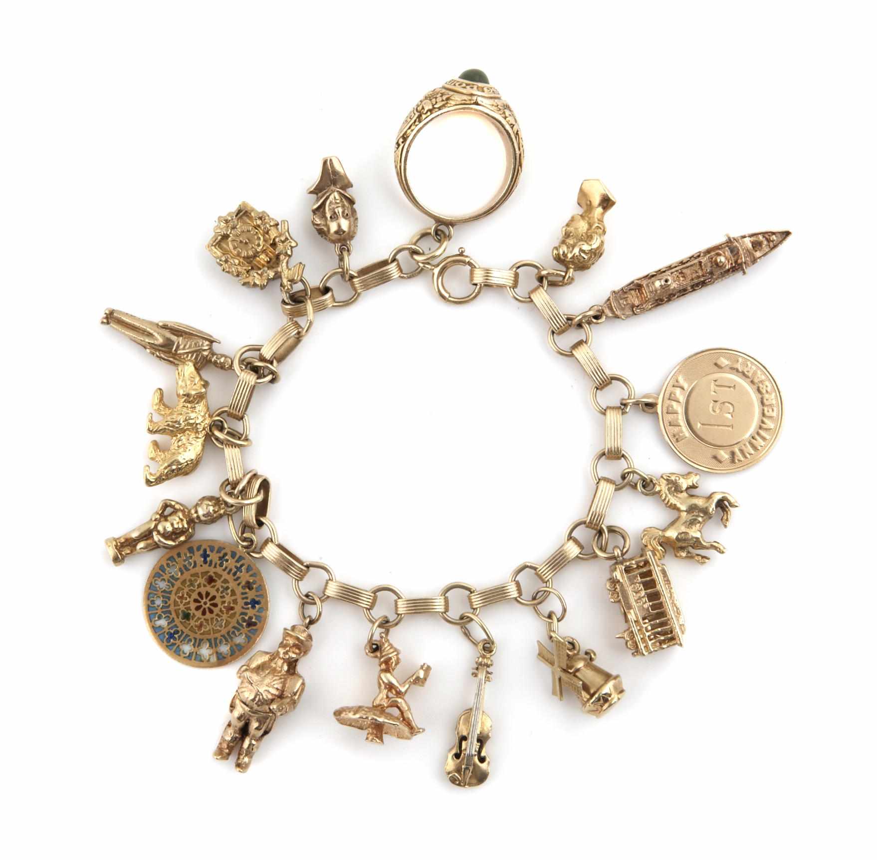 Appraisal: Property of various owners A gold charm bracelet with charms