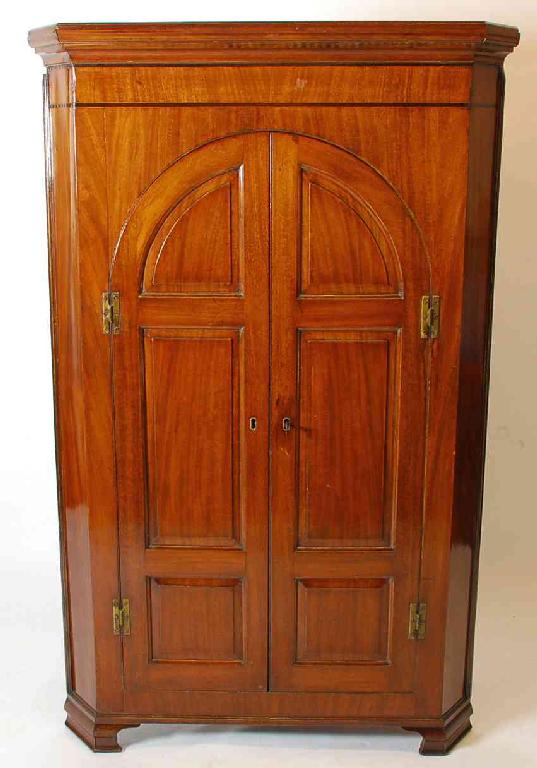 Appraisal: GEORGE III MAHOGANY STANDING CORNER CUPBOARD having ogee and cavetto