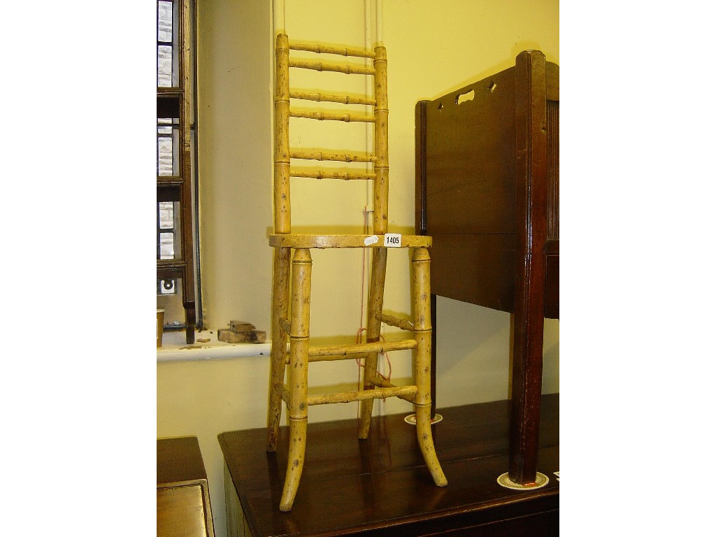 Appraisal: A Regency childs correction chair with painted simulated bamboo frame