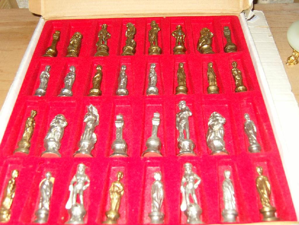 Appraisal: A boxed set of cast metal chess men with pewter