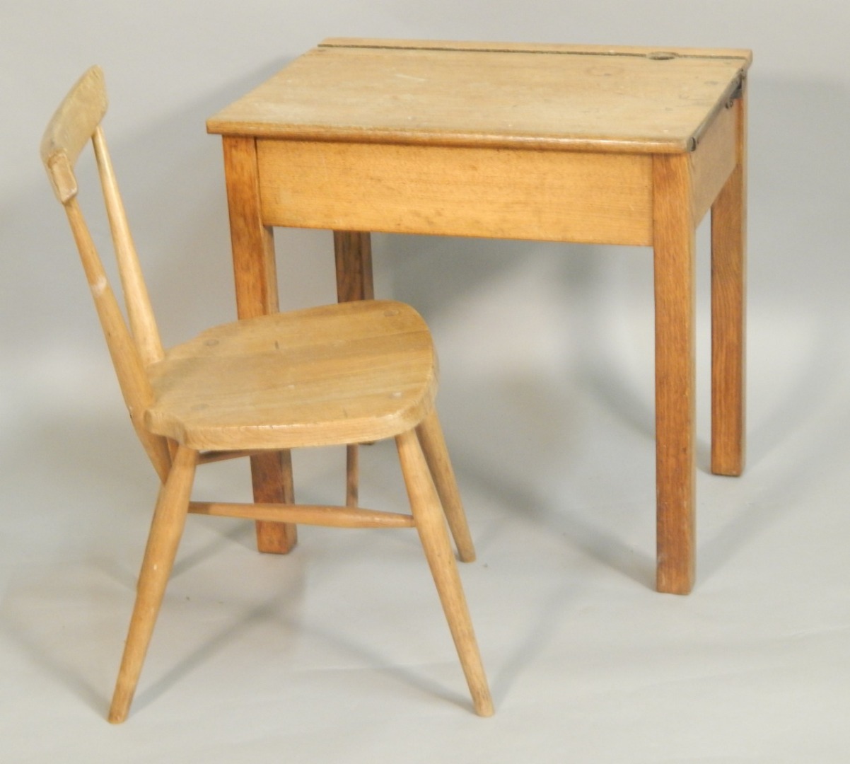 Appraisal: A mid thC child's desk with hinged lid on square