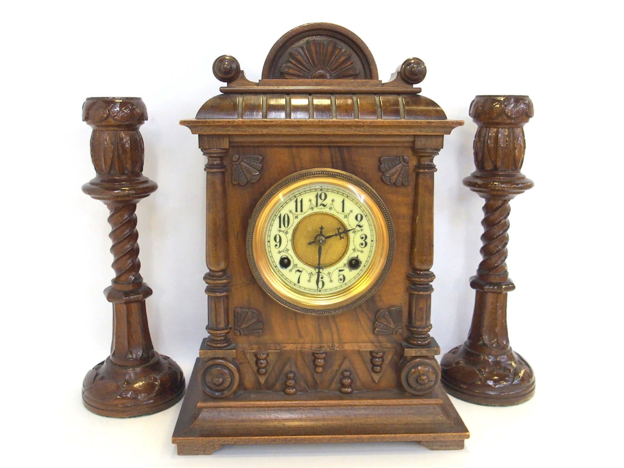 Appraisal: Carved wooden mantle clock and a pair of carved wooden