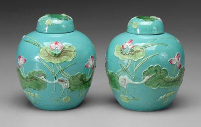 Appraisal: Pair Chinese lidded jars mirror images molded lotuses and waterfowl