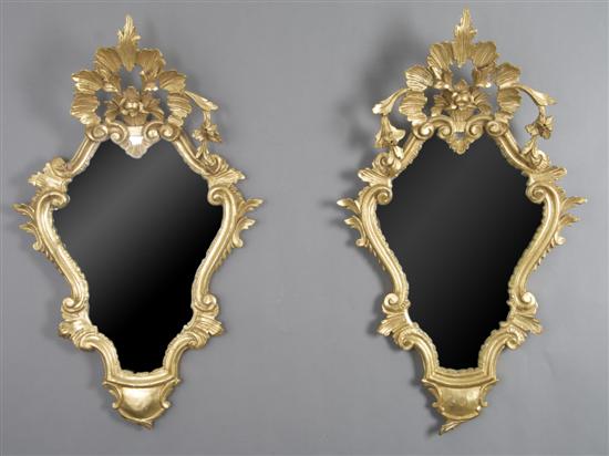 Appraisal: A Pair of Rococo Style Giltwood Mirrors Height x width