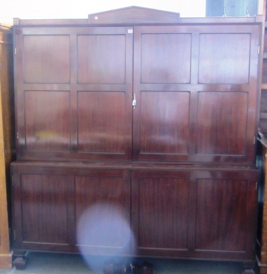 Appraisal: A Regency mahogany house-keeper's cupboard the architectural cornice over two