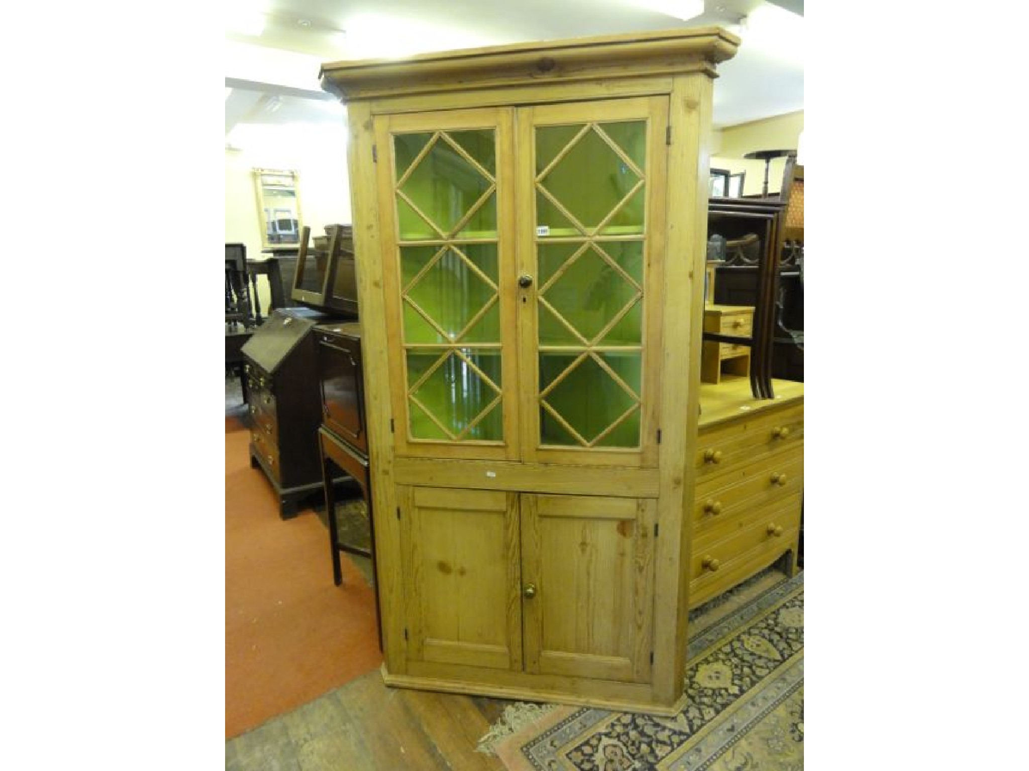 Appraisal: A Georgian stripped and waxed pine freestanding corner cupboard the