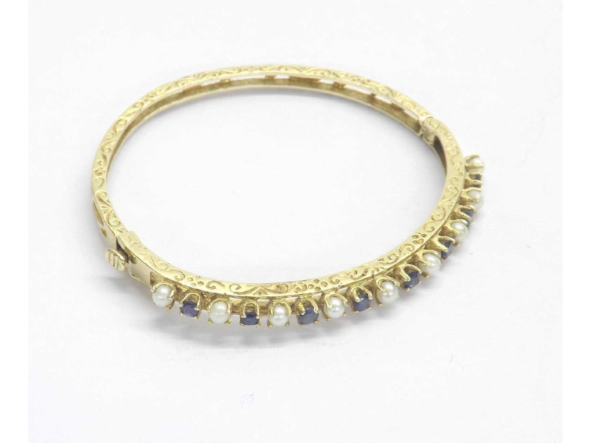 Appraisal: ct yellow gold sapphire and pearl bangle with engraved pierced