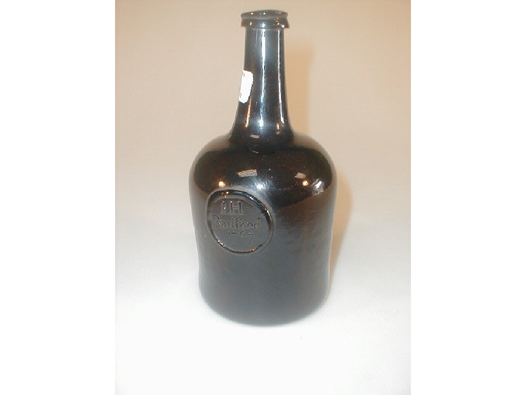 Appraisal: An thC green glass wine bottle with an elongated neck