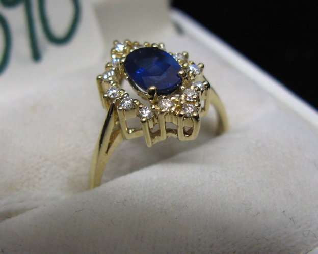 Appraisal: SAPPHIRE DIAMOND AND FOURTEEN KARAT GOLD RING round-cut diamonds surround