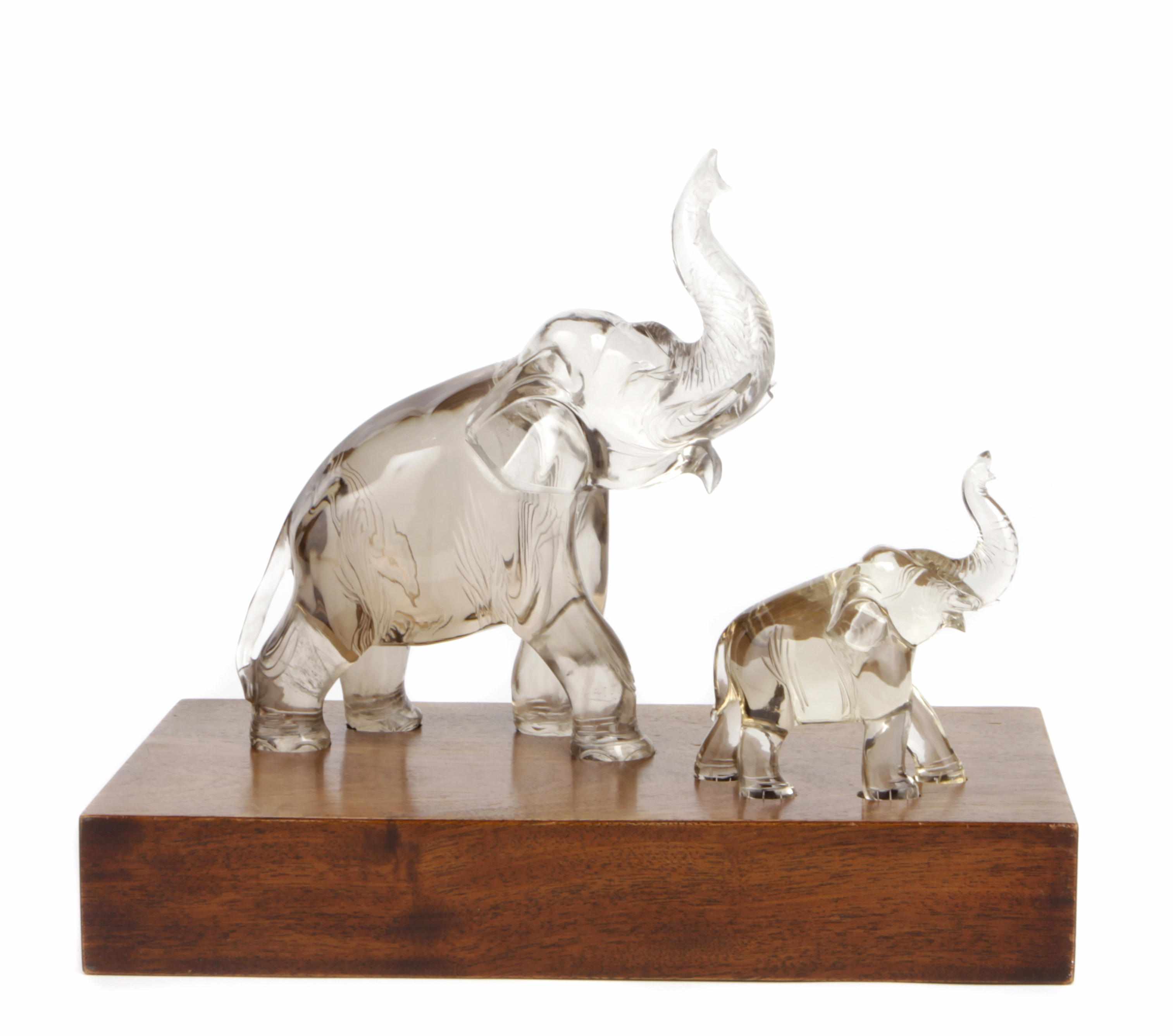 Appraisal: Two Chinese rock crystal elephants on a custom stand th