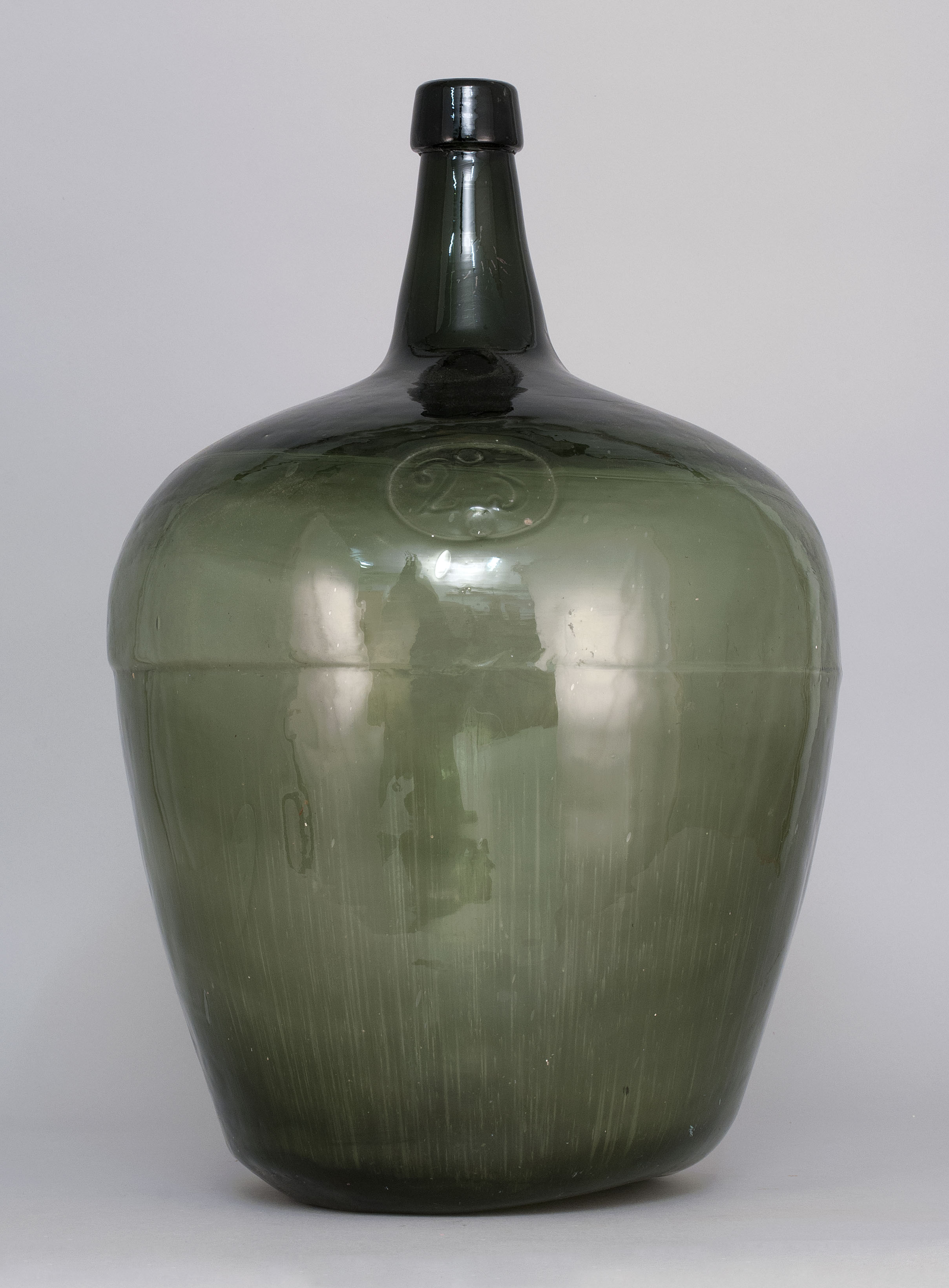 Appraisal: DARK GREEN GLASS DEMIJOHN Mid- th CenturyImpressed oval Rough pontil