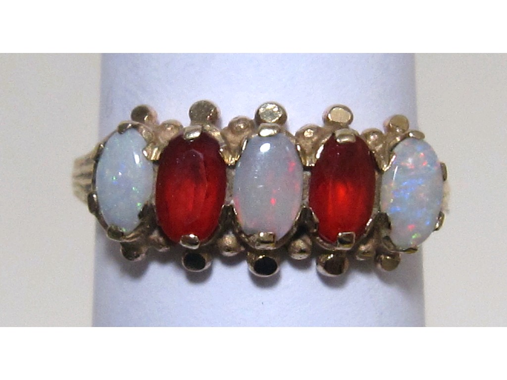 Appraisal: Nine carat gold opal and fire opal five stone ring