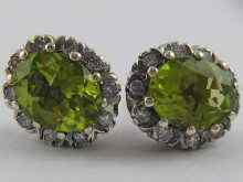 Appraisal: A pair of peridot and diamond earrings set in white