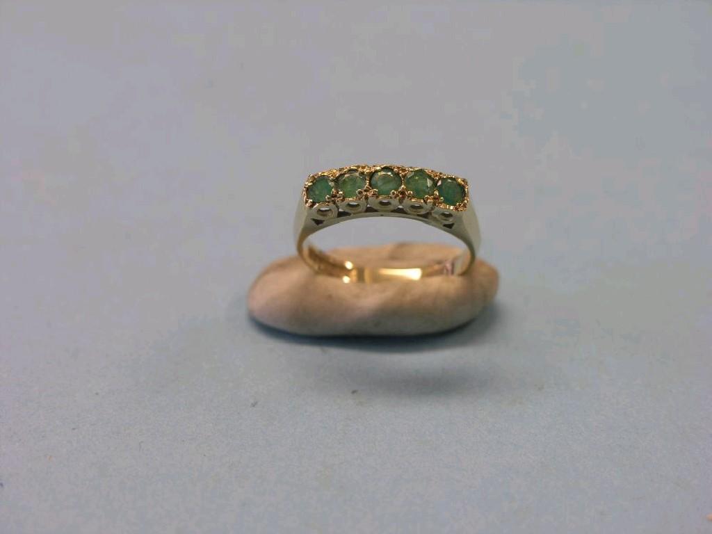 Appraisal: A ct gold and emerald half-hoop ring five stones within