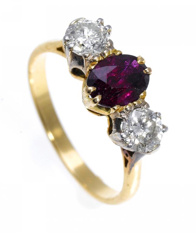 Appraisal: A RUBY AND DIAMOND THREE-STONE RING the oval ruby between