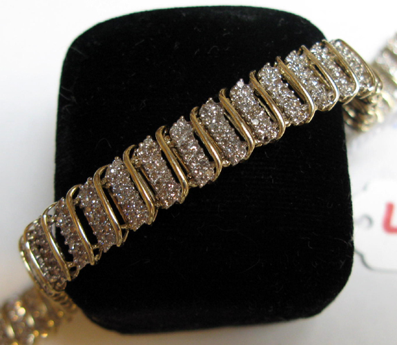 Appraisal: DIAMOND AND FOURTEEN KARAT GOLD BRACELET set with round-cut diamonds