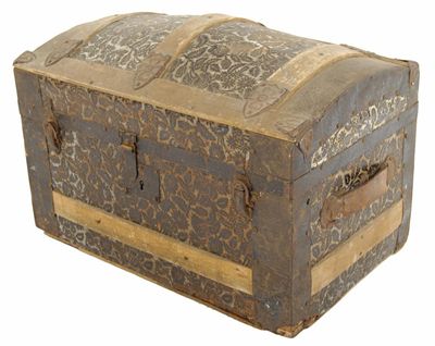 Appraisal: A Spanish domed trunk with floral pressed tin decoration with