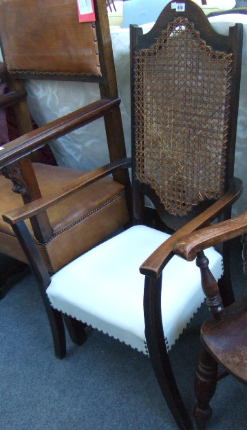 Appraisal: A th century oak framed open arm chair with cane