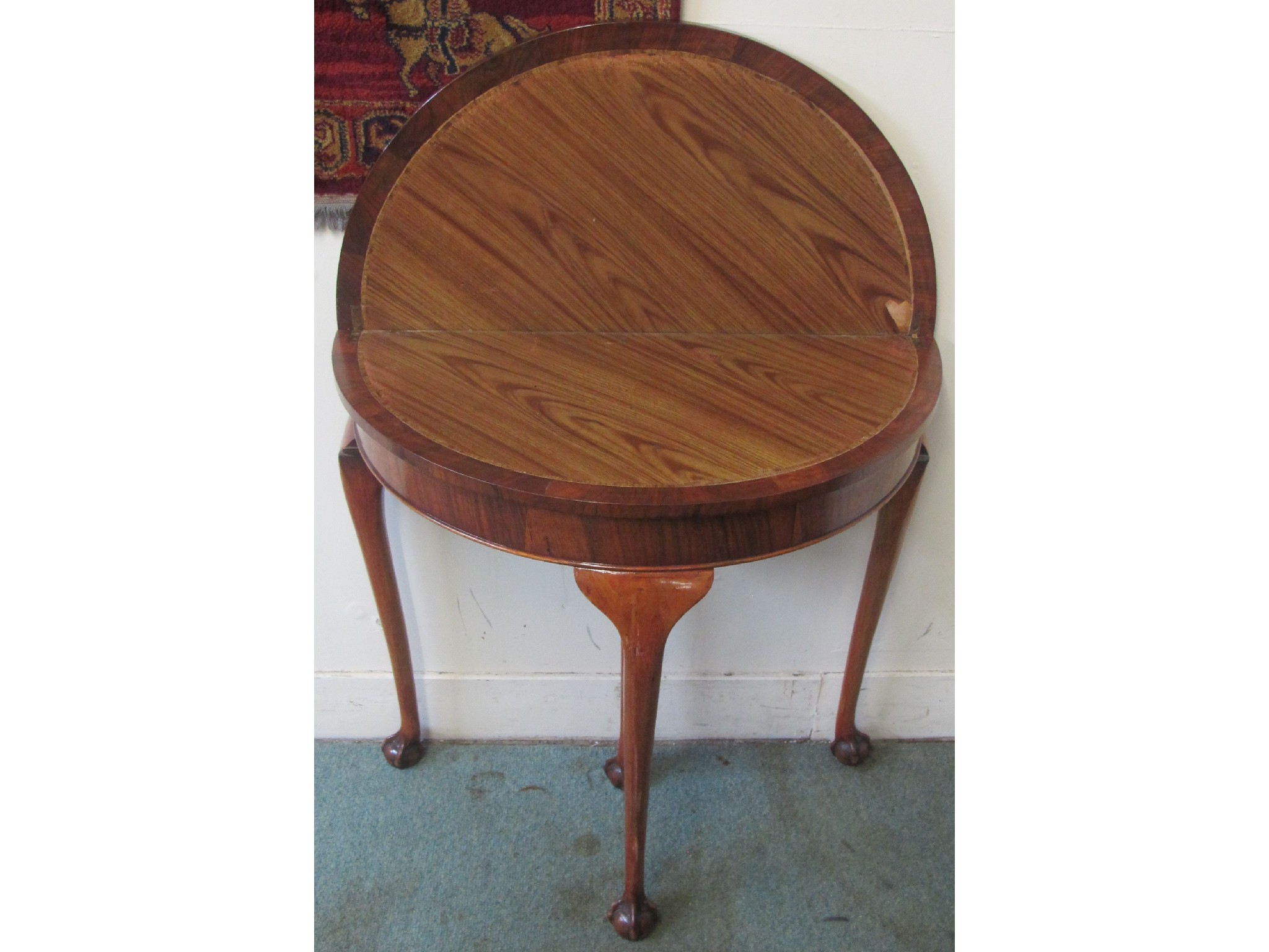 Appraisal: A walnut demi-lune card table