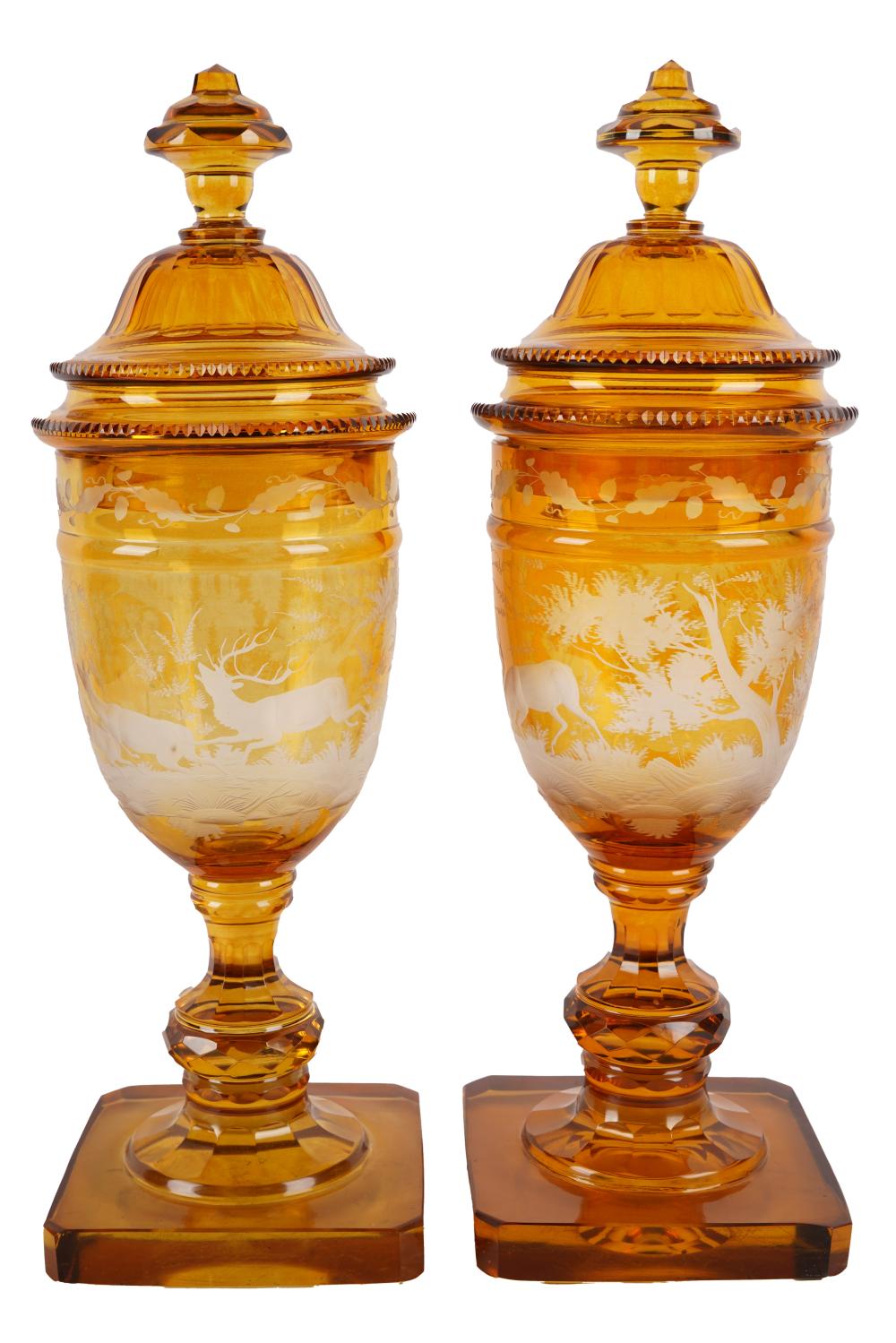 Appraisal: PAIR OF ETCHED AMBER GLASS JARSdepicting scenes of frolicking deer