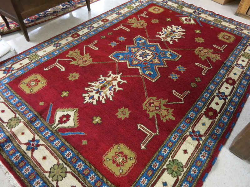 Appraisal: HAND KNOTTED ORIENTAL CARPET Indo-Kazak central geometric medallion and stylized