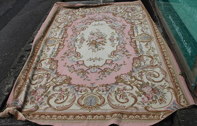 Appraisal: AN AUBUSSON STYLE CARPET with central panel of pink ground