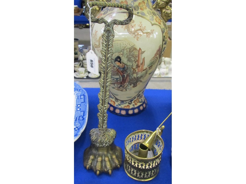 Appraisal: Brass 'hairy paw' doorstop and a candleholder and snuffer