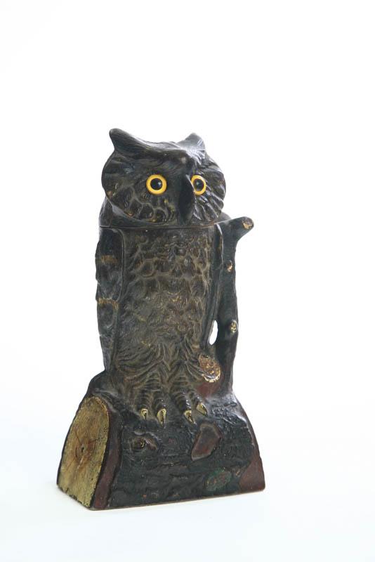 Appraisal: CAST IRON MECHANICAL BANK The owl bank has yellow glass