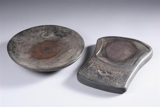 Appraisal: TWO CHINESE PURPLE DUAN INKSTONES One circular with bird-shaped water