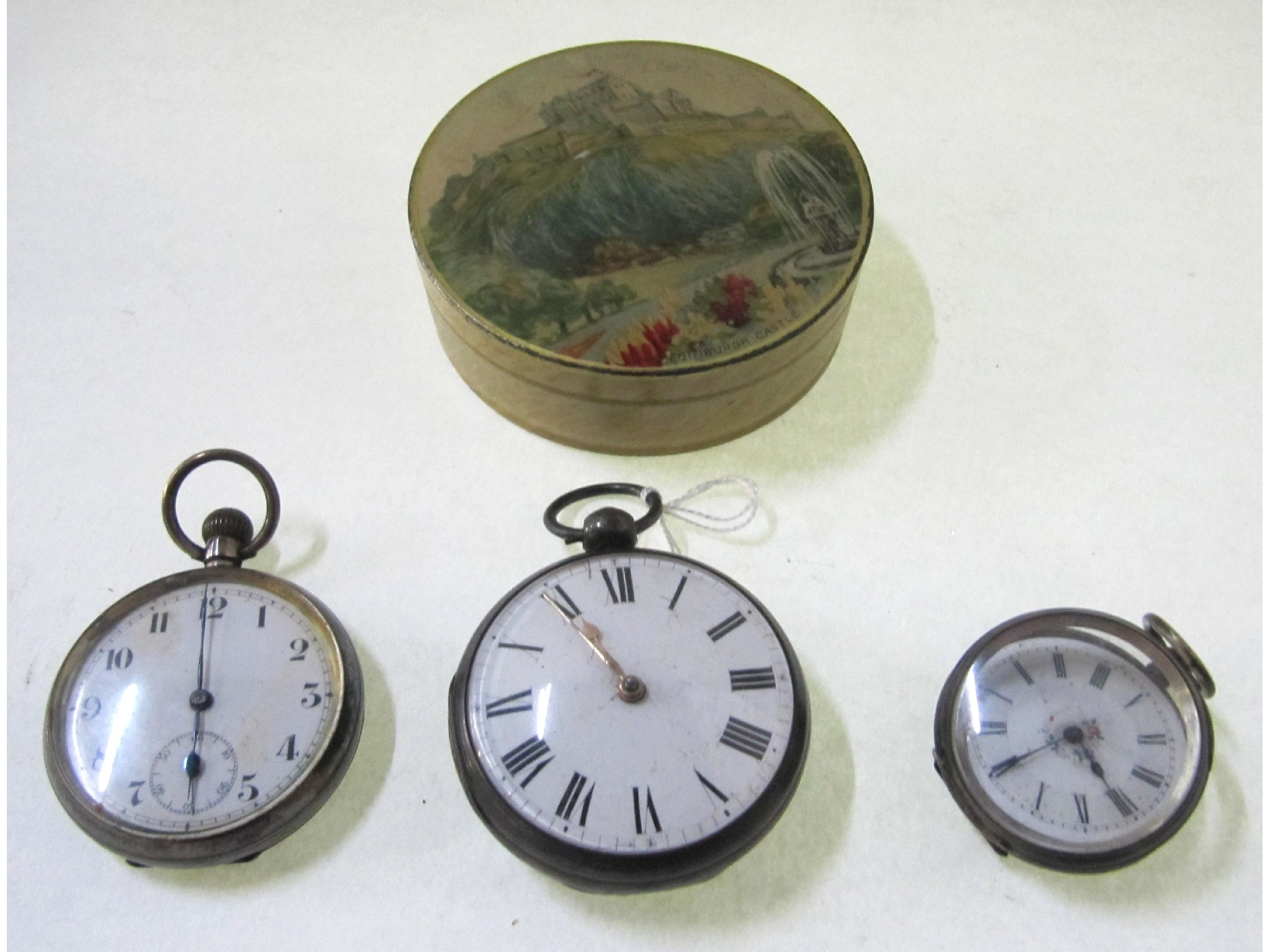 Appraisal: A lot comprising three pocket watches and a tin box