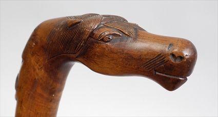 Appraisal: CARVED WOOD CANE WITH HORSE-HEAD HANDLE The horse head above