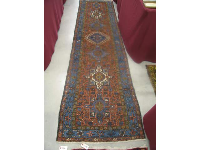 Appraisal: Heriz Persian Handmade Runner goemetric medallions earthtones blue trim '