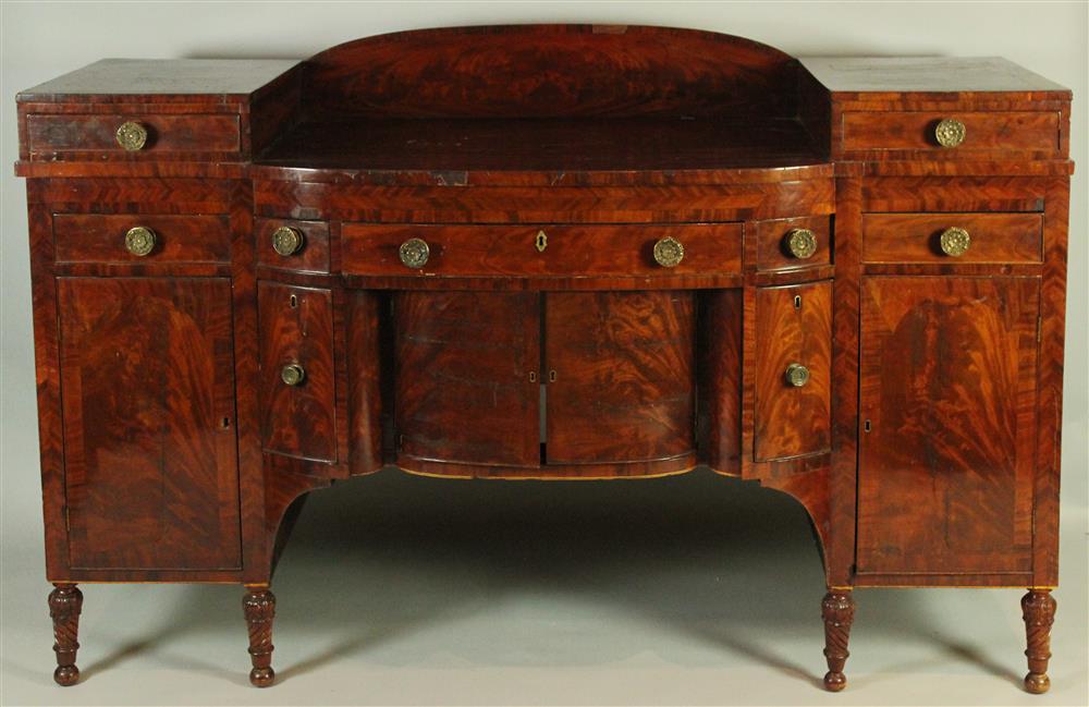 Appraisal: AMERICAN CLASSICAL FIGURED MAHOGANY PEDESTAL SIDEBOARD ca having a bowed