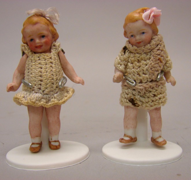 Appraisal: Pair of pink bisque molded loop wire strung jointed dolls