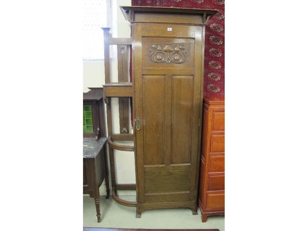 Appraisal: An Art Nouveau oak hall wardrobe with a recess stick