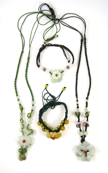 Appraisal: FOUR ARTICLES OF JADE JEWELRY including a black cord necklace