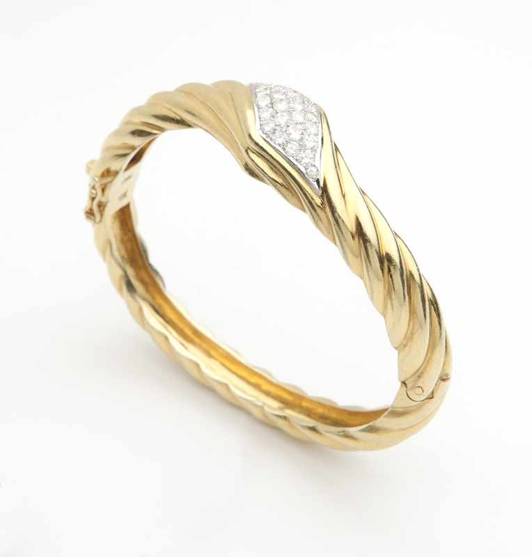 Appraisal: A diamond and gold rope bangle Stamped K oval-shaped set