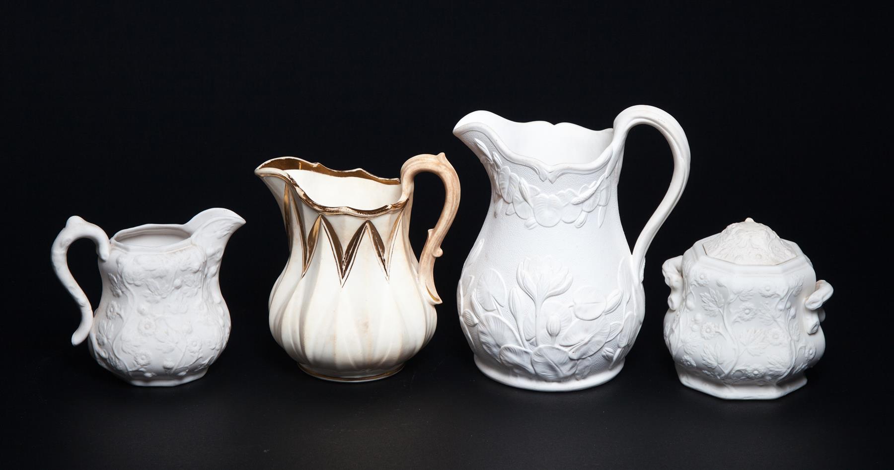 Appraisal: FOUR PIECES OF BENNINGTON POTTERY Mid th century Parian pitcher