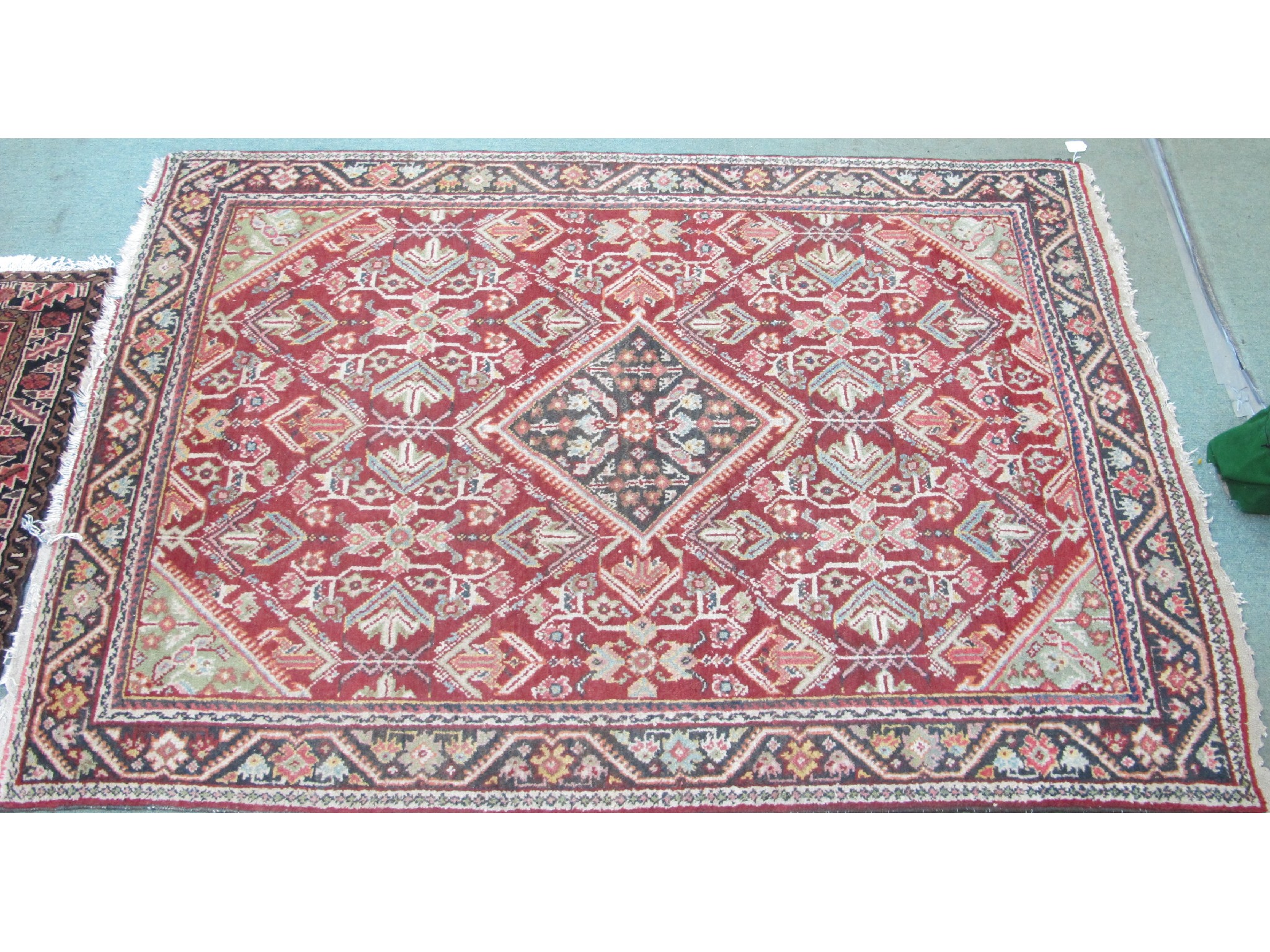 Appraisal: An Eastern rug on a red and cream ground cm