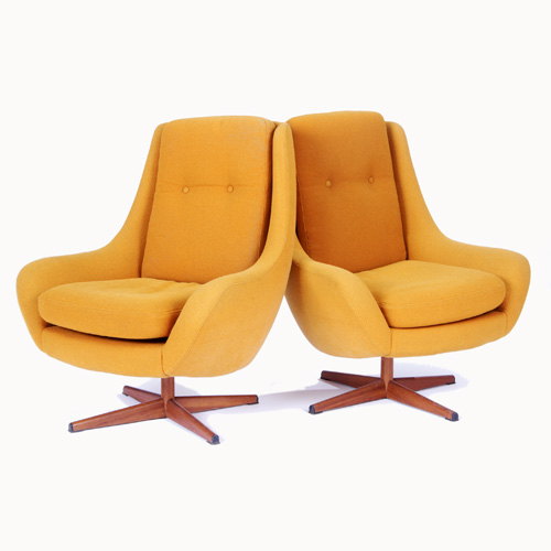 Appraisal: SCANDINAVIAN Pair of lounge chairs with amber fabric upholstery on