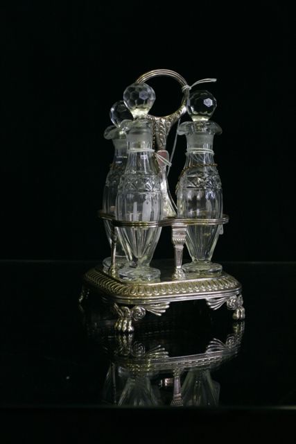 Appraisal: A sterling silver cruet set with four receptacles by Rebecca