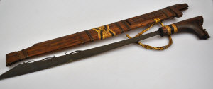 Appraisal: A Polynesian steel blade with wooden grip in two piece