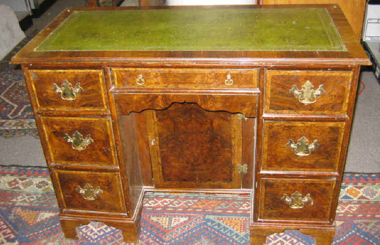 Appraisal: ENGLISH WALNUT KNEEHOLE WRITING DESK With tooled leather top over