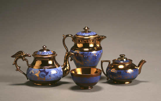 Appraisal: Group of Four English Copper Lustre Decorated Blue Slip Tea