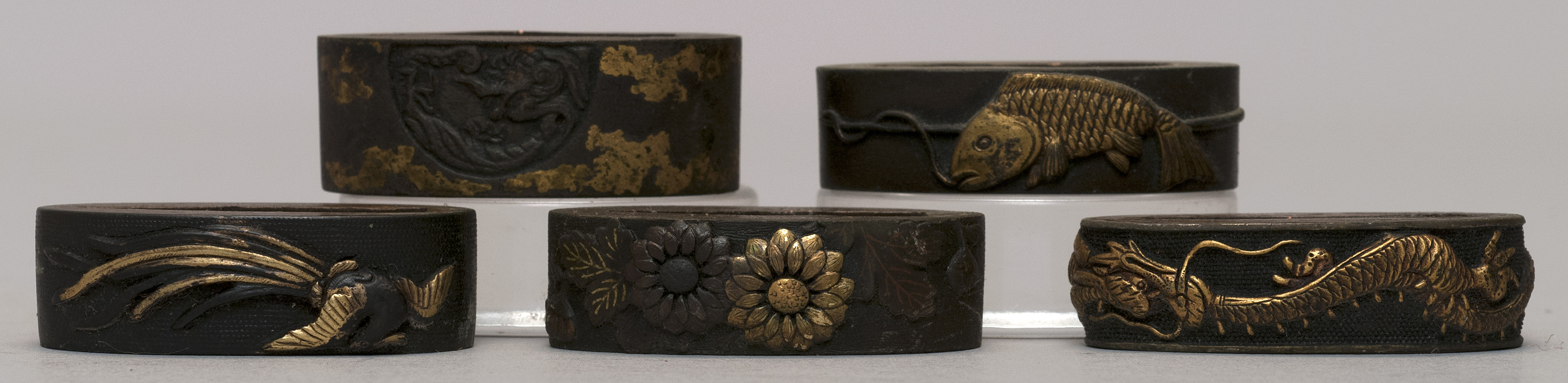 Appraisal: FIVE FUCHI th CenturyTwo in dragon design one with carp