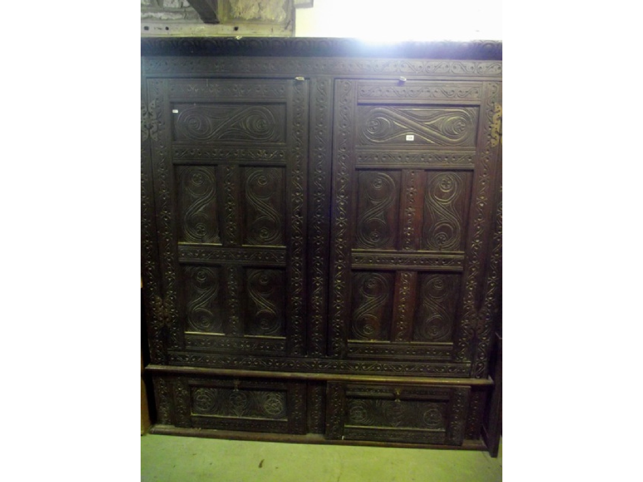 Appraisal: An antique oak hanging cupboard with carved and moulded panelled