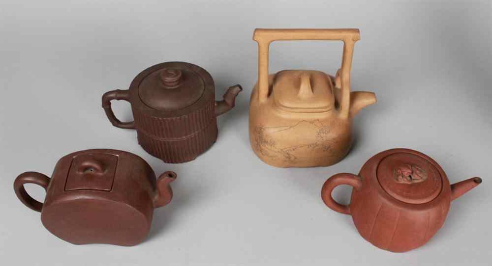 Appraisal: FOUR CHINESE YIXING TEAPOTS Including a compressed buff example of