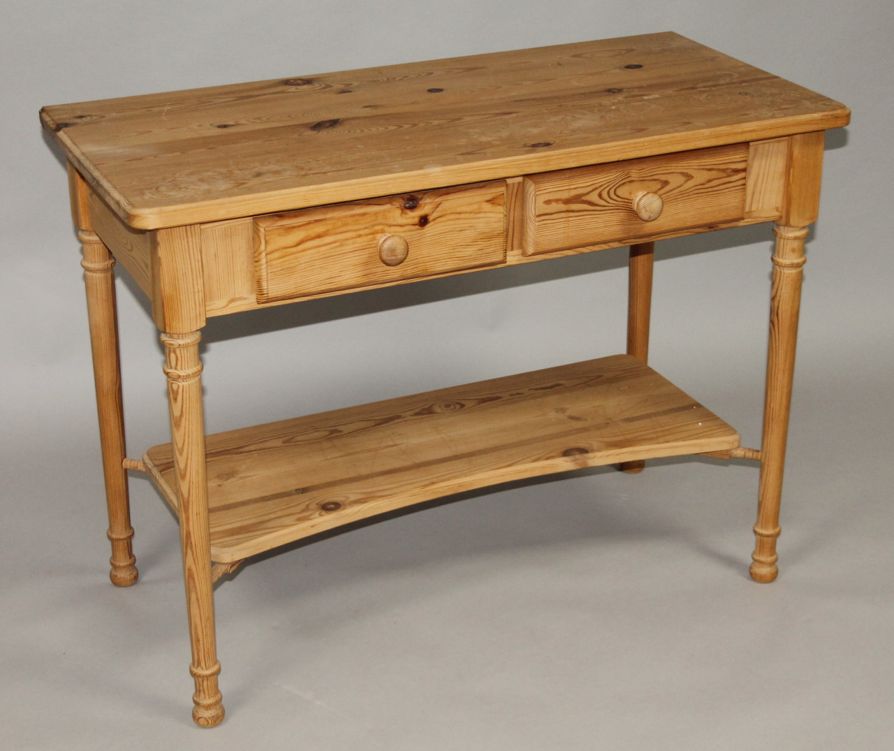 Appraisal: A stripped and lightly polished pine dressing table the overhanging